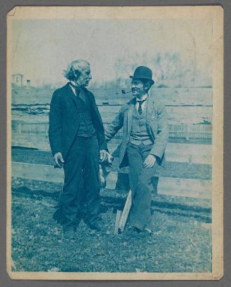 Maurice Prendergast, Sr. and Charles Prendergast standing in front of fence