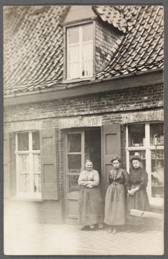 Unknown friends or relatives; three women in front of building