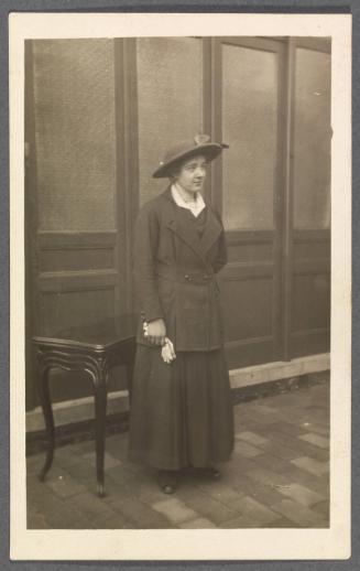 Unknown friends or relatives; woman in hat standing