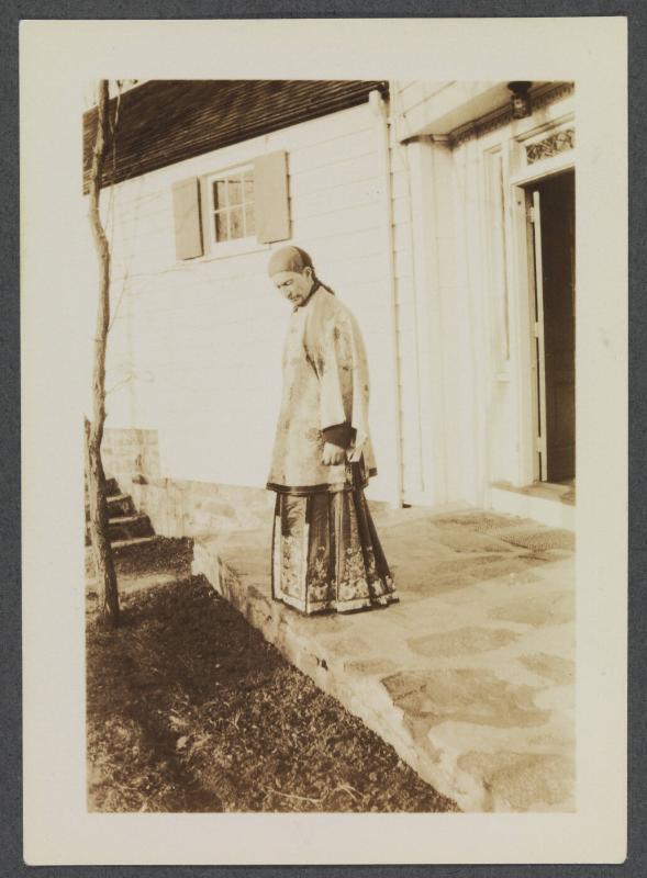 1927-1929 series of Eugénie and Charles Prendergast and Vankemmel family members in France; woman standing in front of house