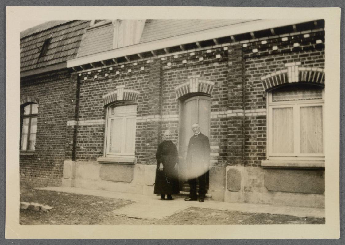 1927-1929 series of Eugénie and Charles Prendergast and Vankemmel family members in France; couple standing in front of building