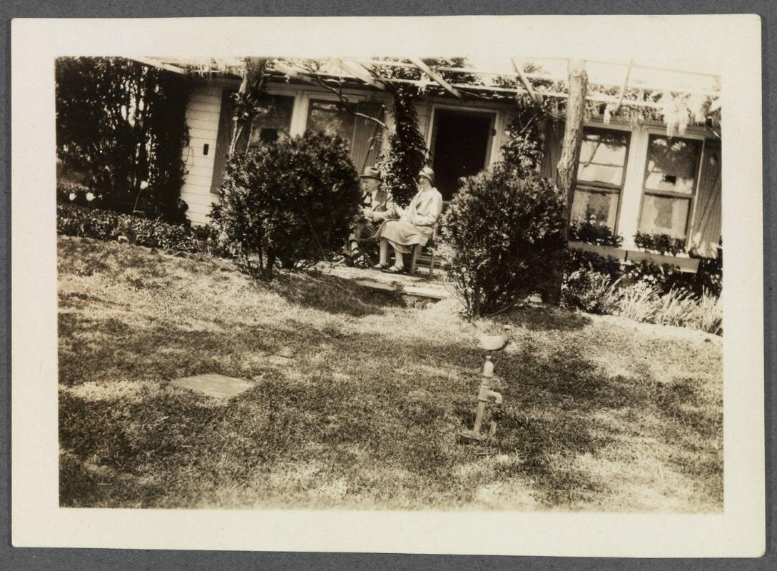 1927-1929 series of Eugénie and Charles Prendergast and Vankemmel family members in France; Eugénie and Charles Prendergast seated in front of house
