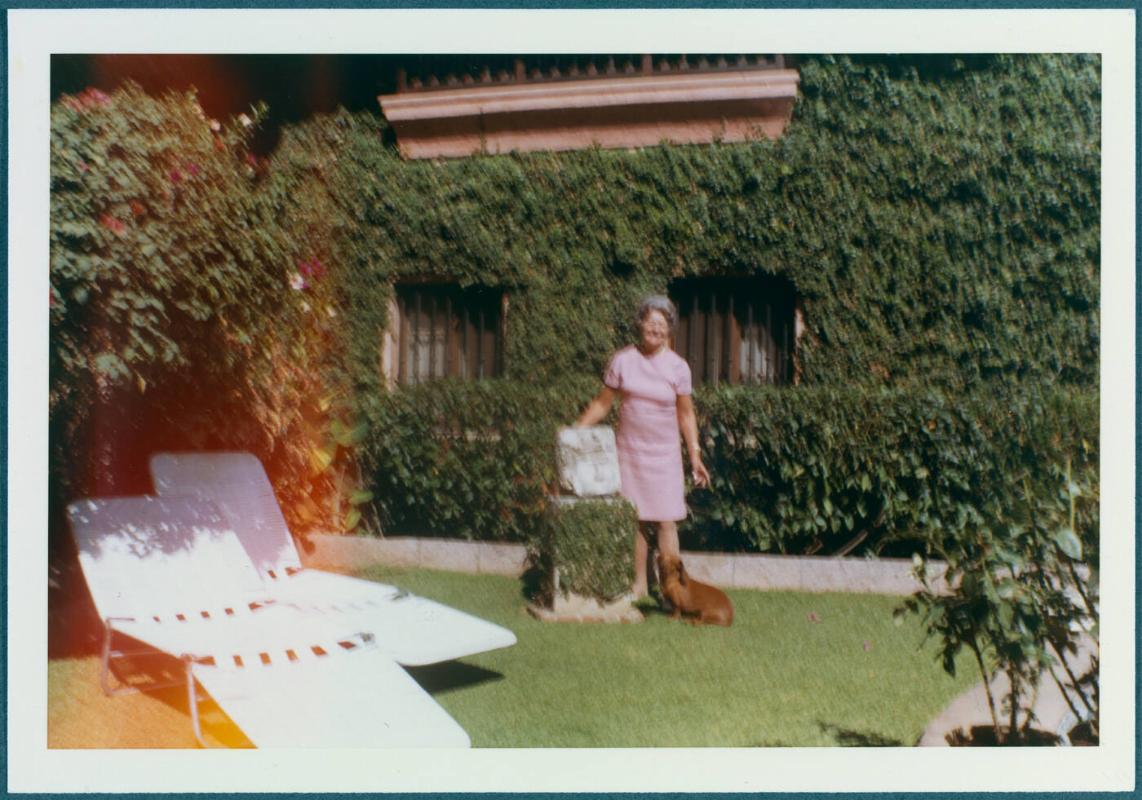 Cuernavaca, Mexico home of Robert Brady; Woman with dog in yard