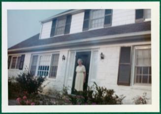 Series of house on Compo Road including Eugénie Prendergast; Eugénie Prendergast standing outside in doorway
