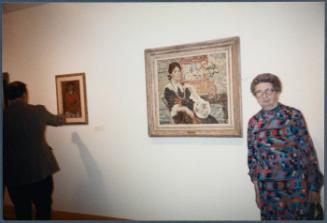 Series of a dinner at Williams College Museum of Art including Eugénie Prendergast and others; (L to R) Eugénie Prendergast in front of Prendergast painting
