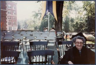 Eugénie Prendergast receiving her honorary degree at 1985 Williams College Commencement ceremony including friends and college officials; Eugénie Prendergast seated on stage