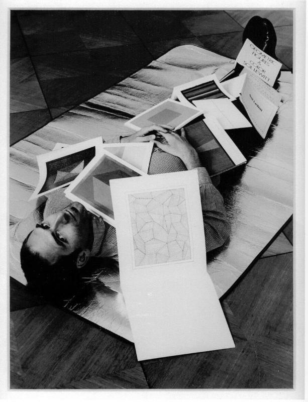 The artist covered in a selection of his Sol LeWitt books (cut) (after Ed Ruscha) Up