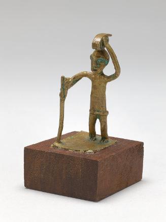 Gold weight in the form of a man with walking stick and head load