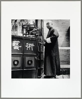 Man Operating a Folk Art Slide Show, Beijing (from "The Chinese")