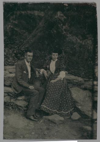 Portrait of a couple sitting in a rocky landscape