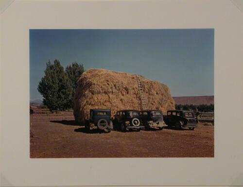 Haystack and automobile of peach pickers, Delta County, CO