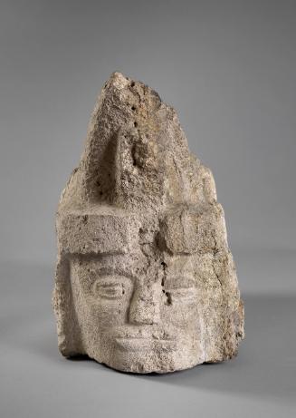 Human Head Wearing a Peaked Headdress