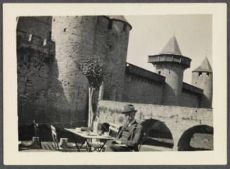 Eugénie and Charles Prendergast 1927 tour of France and Monaco; Charles Prendergast seated at outdoor table in Carcassone