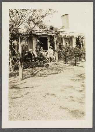 1927-1929 series of Eugénie and Charles Prendergast and Vankemmel family members in France; Eugénie and Charles Prendergast, and woman seated in front of house