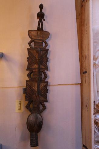 Plank mask with figure atop (crocodile?)