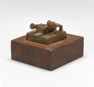 Gold weight in the form of a man firing two mounted cannons