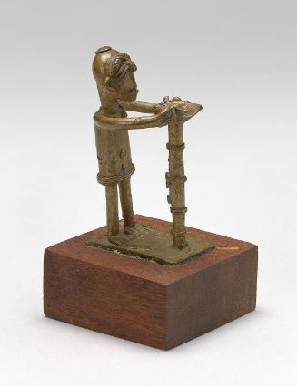 Gold weight in the form of a man before "God's Tree"