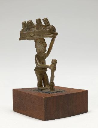 Gold weight in the form of a man carrying calabashes