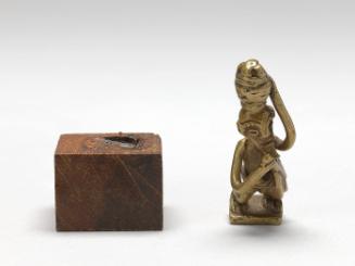 Gold weight in the form of an herbalist carrying a shrine