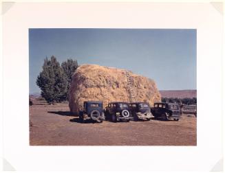 Haystack and automobile of peach pickers, Delta County, CO